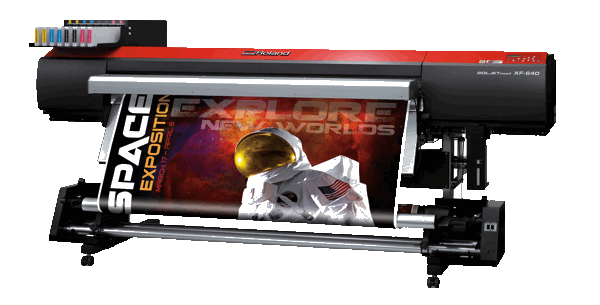 Large format printer printing a large vinyl banner with space graphic on it